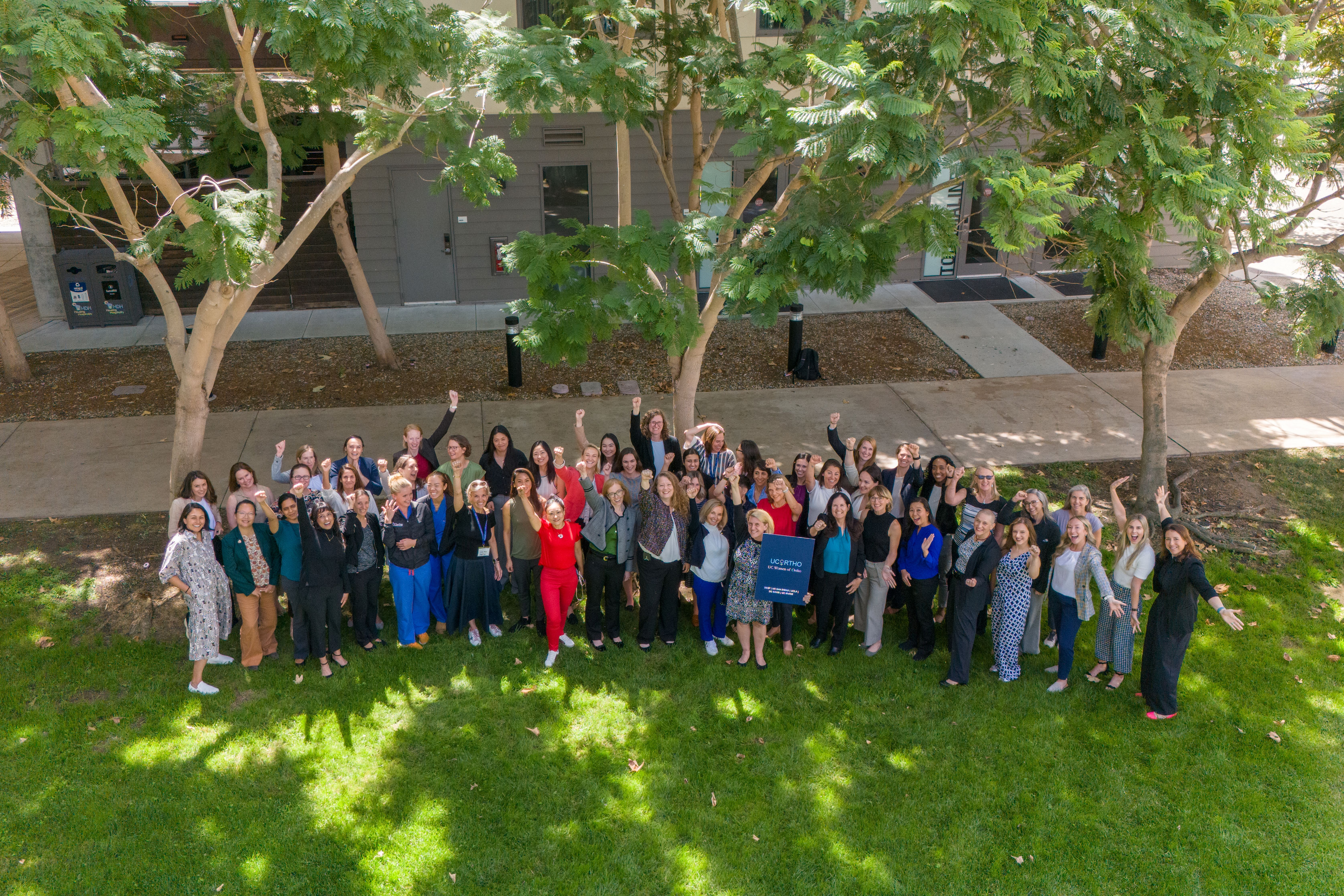 UC Women of Ortho stand and smile looking up at the camera